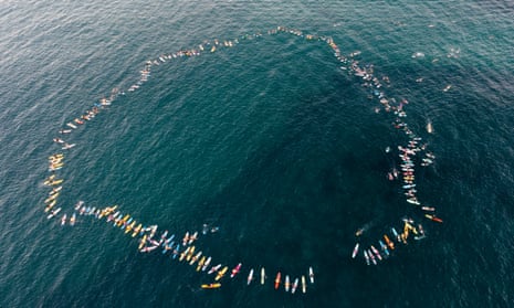 Hundreds gather in a circle in the water off Bondi Beach at dawn, commemorating the Westfield Bondi Junction victims.