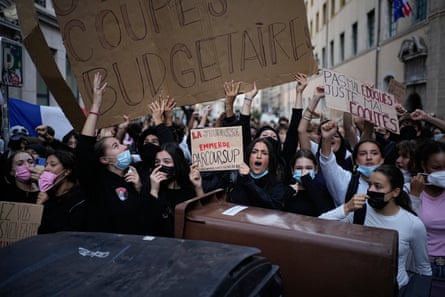Students hold a sign reading ‘stop budget cuts’