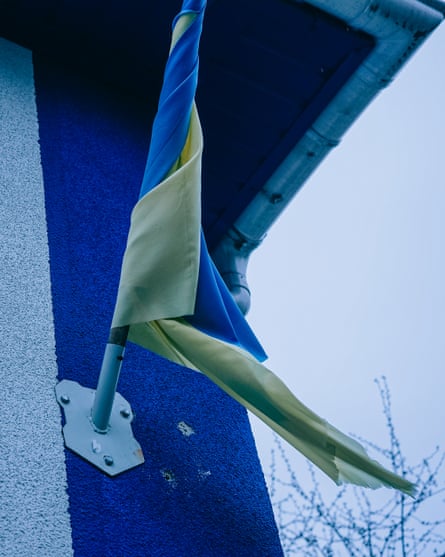 A national flag of Ukraine partly rolled up by the wind on a pole outside the rehab centre
