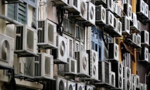 Rows of air conditioners are seen on the walls of a building in Singapore's financial district