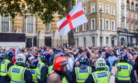 Protesters clash with police in Westminster while flying St George’s flag