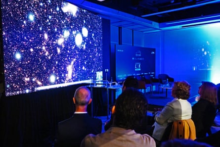 Dark room with starry images projected on wall