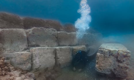 Underwater archaeologist Matej Školc carefully excavates the foundations of an ancient harbour structure.