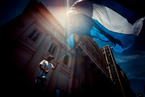 A man waves an Argentinian flag.