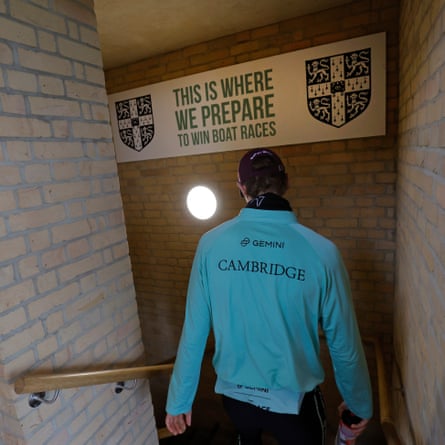 A member of the Cambridge University Boat Club men’s blue boat descends the stairs to where the boats are kept in the boathouse at their Ely training site in Cambridgeshire.