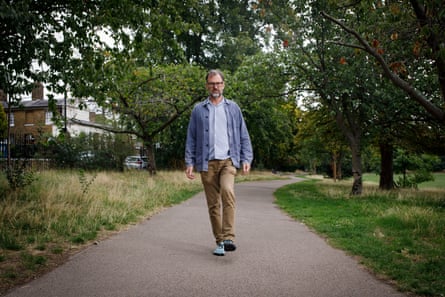 Tim walking along a path in his local park