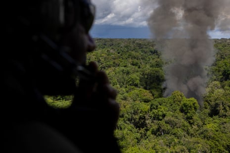 Smoke rises above the forest