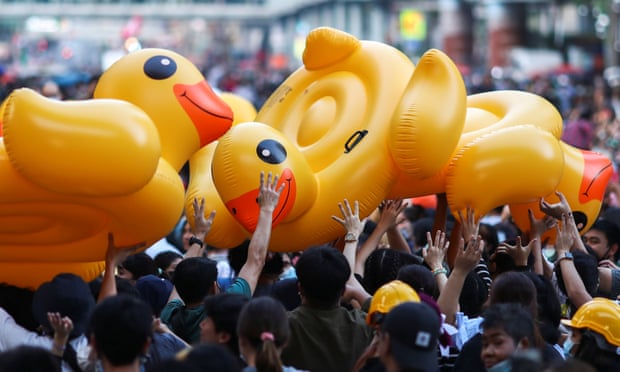 Demonstrators carry inflatable ducks during a rally in Bangkok on Wednesday