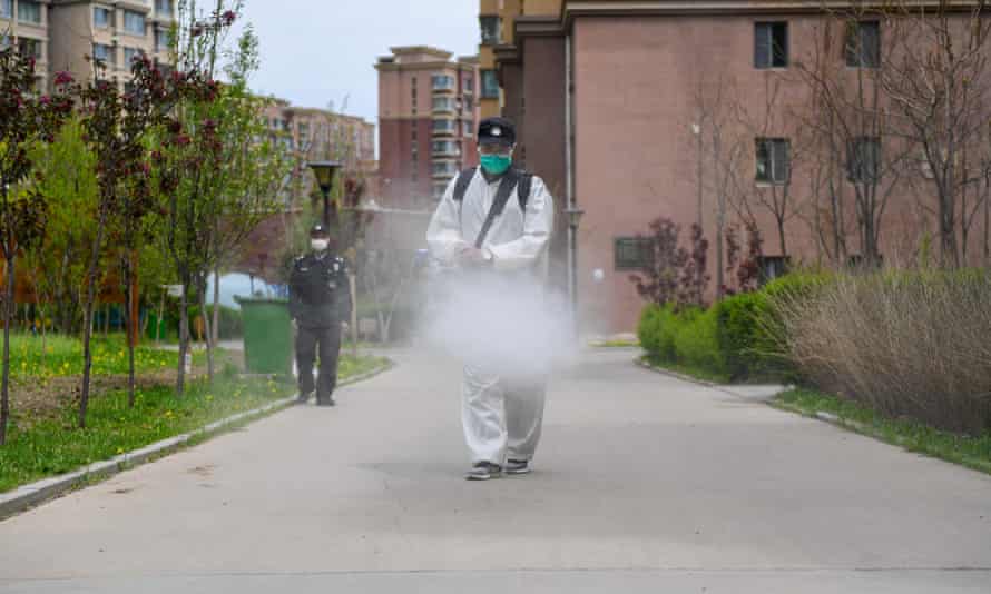 A worker disinfects a residential community in Jilin city, in north-east China’s Jilin Province.