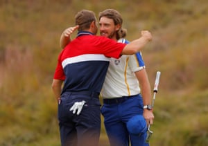 Team Europe’s Tommy Fleetwood hugs Team USA’s Jordan Spieth on the 18th green.
