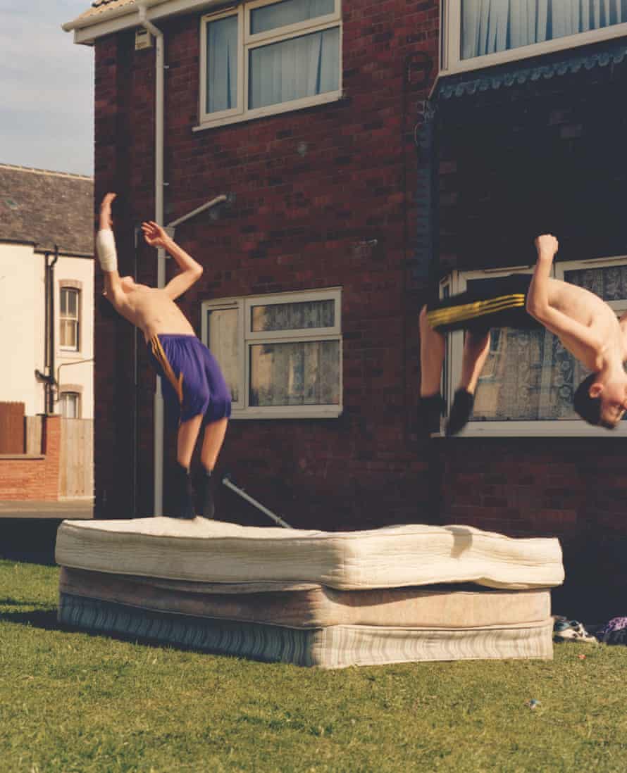 Image from The British Isles by Jamie Hawkesworth of two young men backflipping on some mattresses