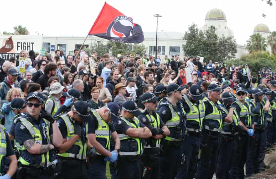 Police keep rival activists apart on the St Kilda foreshore.