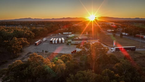 A drone shot of the sun rises over the truckstop