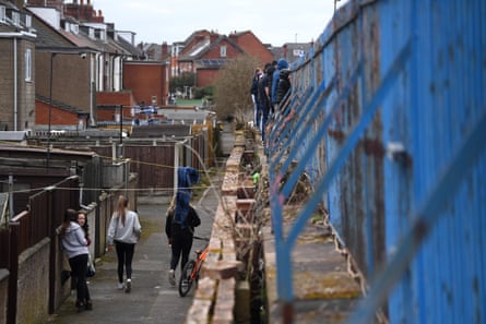 Featherstone fans watch play from behind the terrace fence during the Challenge Cup match against Bradford Bulls in March 2021