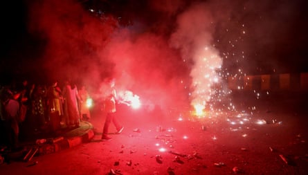 People light red sparklers and crackers