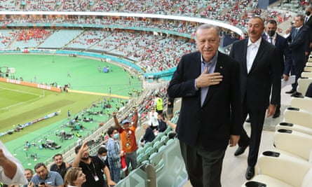 Turkey’s president, Recep Tayyip Erdogan, and Azerbaijan’s president, Ilham Aliyev, arrive to watch the game