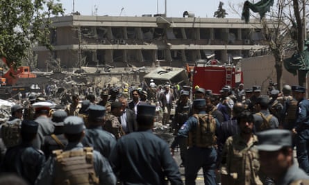 Security forces inspect the site of a suicide attack near the German embassy in Kabul