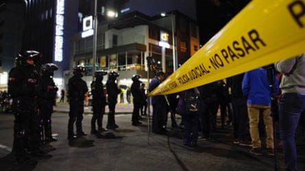 Police officers guard the hospital where Villavicencio was taken after being shot at a rally in Quito.