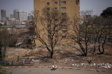 People walk past garbage outside a tower block in Hillbrow, Johannesburg.