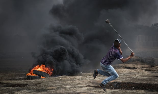 Protesters burn tyres and throw rocks at Israeli forces near the Gaza-Israel border on 11 May.