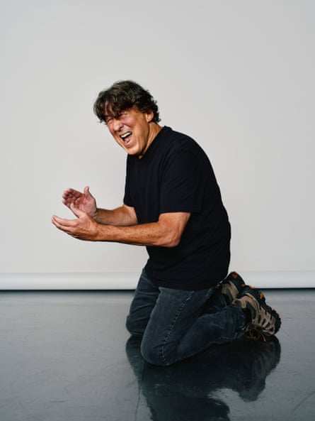 Crowe kneels on the ground, eyes closed tightly, mid-clap to recreate a photograph of him shot in Los Angeles in 1978.