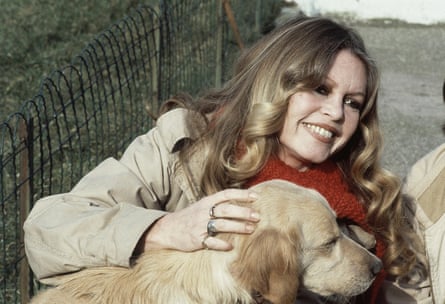 Brigitte Bardot strokes a dog