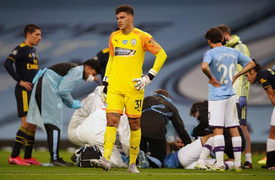 Ederson reacts as medics tend to Garcia as he lays injured.