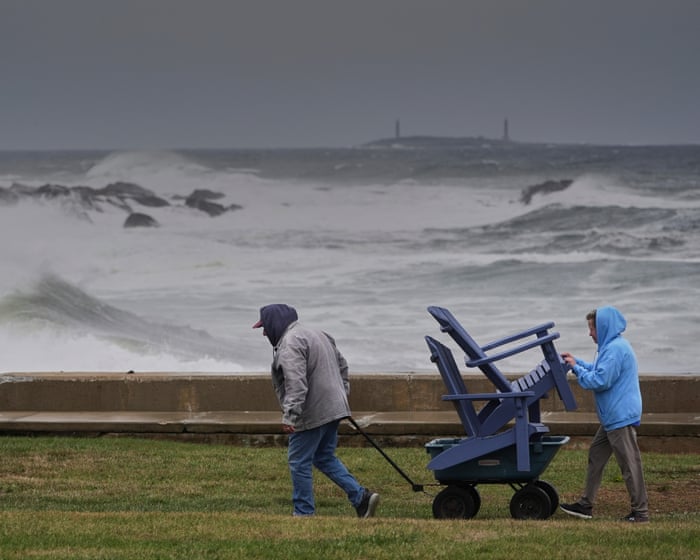 Power outages and flooded roads as major storm bears down on US north-east