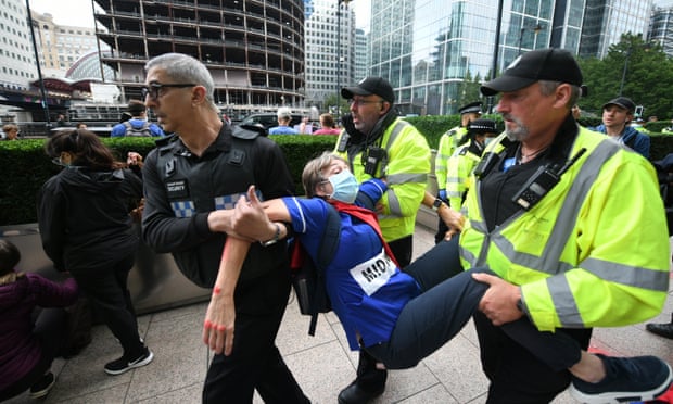 A protester is carried away by security guards