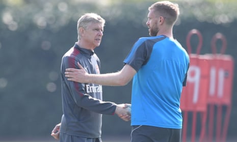 The Arsenal manager, Arsène Wenger, shakes hands with Per Mertesacker before a training session at London Colney on Saturday.