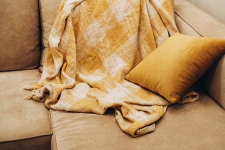 Crumpled throw and cushion on couch