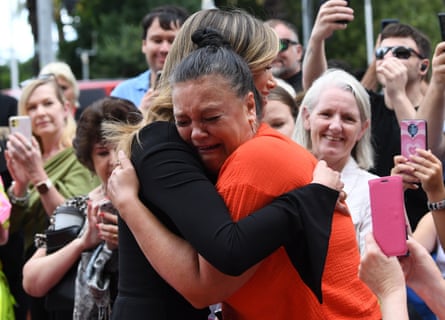 Singer Delta Goodrem hugs fan Justine Edwards outside a state memorial service for Olivia Newton-John at Hamer Hall in Melbourne.