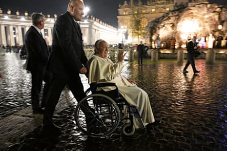 Pope Francis waves to onlookers from his wheelchair at St Peter’s Square in the Vatican earlier today.