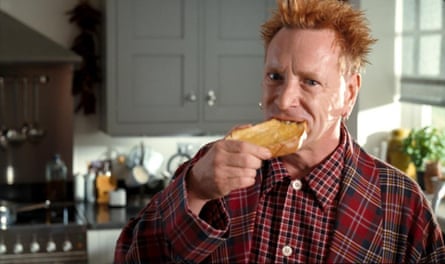 He bites into a piece of buttered toast
