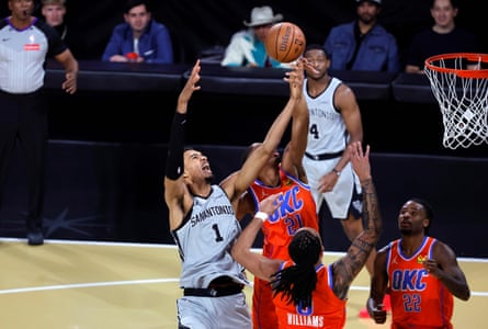 Victor Wembanyama #1 of the San Antonio Spurs grabs a rebound by Aaron Wiggins #21, Jalen Williams #8, and Cason Wallace #22 of the Oklahoma City Thunder in the second quarter of a semifinal game of the Emirates NBA Cup at T-Mobile Arena on December 13, 2025 in Las Vegas, Nevada.