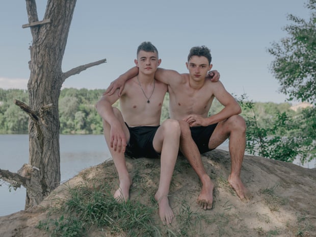 Grisha (left) and Borys, two best friends, swim in a lake near Irpin