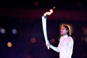 Cathy Freeman holds the Olympic torch prior to lighting the Olympic flame during the opening ceremony.