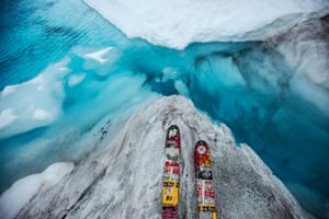 A skier overlooks a glacial pool in the upper Ruth Glacier in Denali National Park and Preserve.