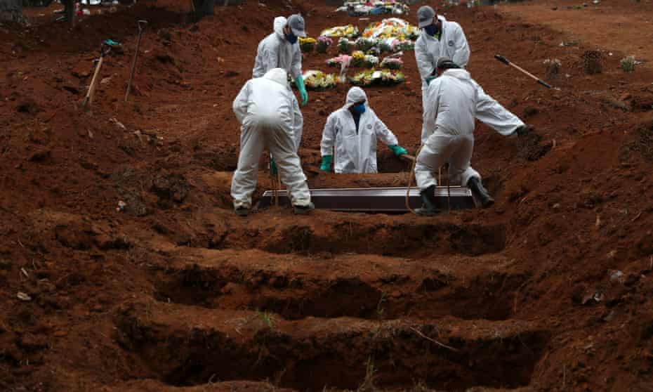 Gravediggers wearing protective suits bury the coffin of Jose Soares, 48, who died from Covid-19, at São Luiz cemetery, in São Paulo, Brazil, on Thursday.