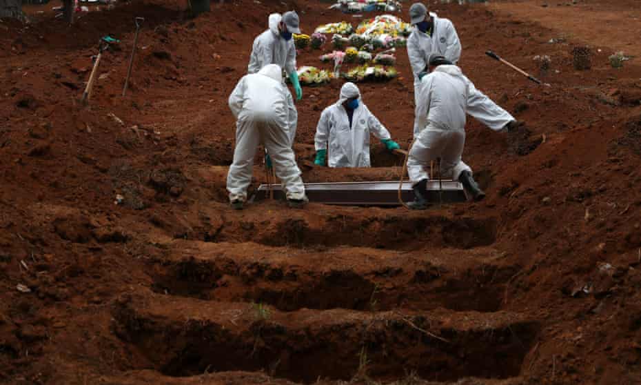 Gravediggers wearing protective suits bury a coronavirus victim in Sao Paulo, Brazil.