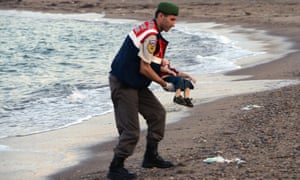 A paramilitary police officer carries the lifeless body of Aylan Kurdi after the boat carrying his family to the Greek island of Kos capsized near the Turkish resort of Bodrum on Wednesday 2 September.