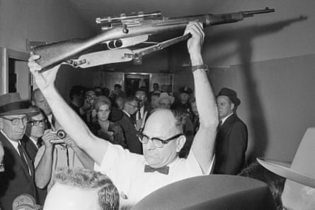 A Dallas policeman holds up the rifle used to kill Kennedy on 22 November 1963.
