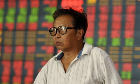 An investor in front of a stock information board in Fuyang, Anhui province, China