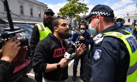 Right-wing activist Avi Yemini reacts to a police officer during a counter protest against anti-vaxxers, the far-right and fascism in Melbourne, Saturday, November 20, 2021. The Campaign Against Racism & Fascism group is planning rallies in capital cities to protest against "the far-right, anti-vaxxers, and anti-lockdowners. (AAP Image/Joel Carrett) NO ARCHIVING