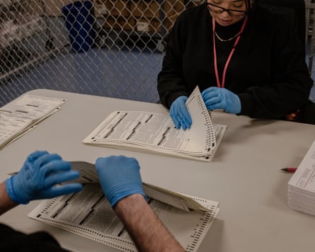 people look at ballots on table