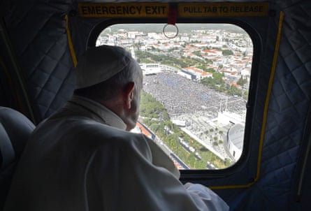 Francis looks at the crowd gathering in the Sanctuary of Our Lady of Fátima from the window of his helicopter.