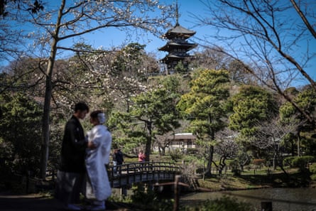 A bisexual couple pose for wedding photos in a traditional garden in Yokohama