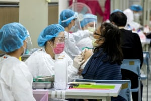 A woman receives a booster shot of the Covid-19 vaccine at a community center, in Taipei, Taiwan, on 17 January, 2022.