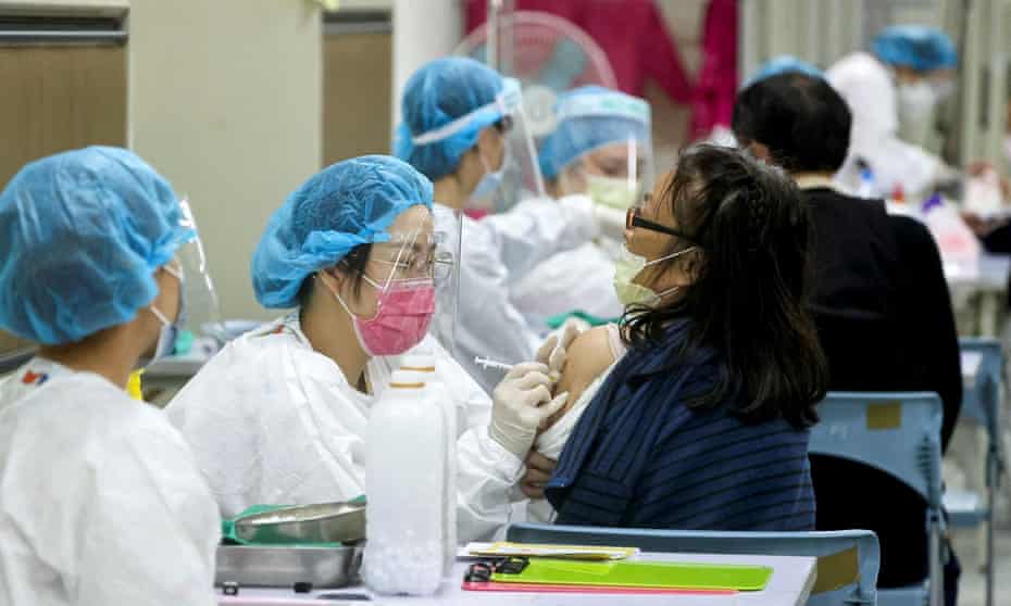 A woman receives a booster shot of the Covid-19 vaccine in Taipei.