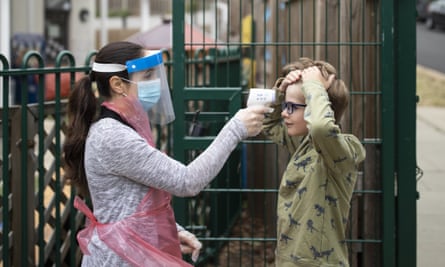 A member of staff takes a child’s temperature at the Harris primary academy Shortlands, London, on 4 June.